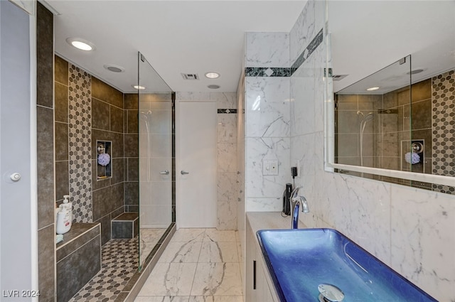 bathroom featuring a tile shower, vanity, and tile walls