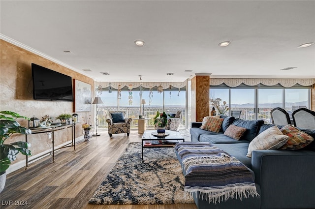 living room featuring hardwood / wood-style flooring and ornamental molding