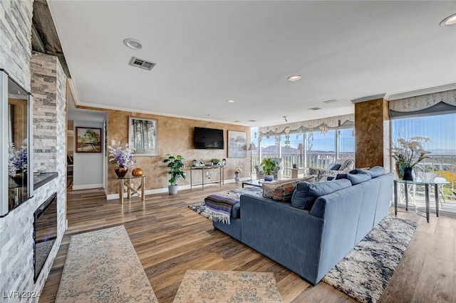 living room with hardwood / wood-style flooring and crown molding