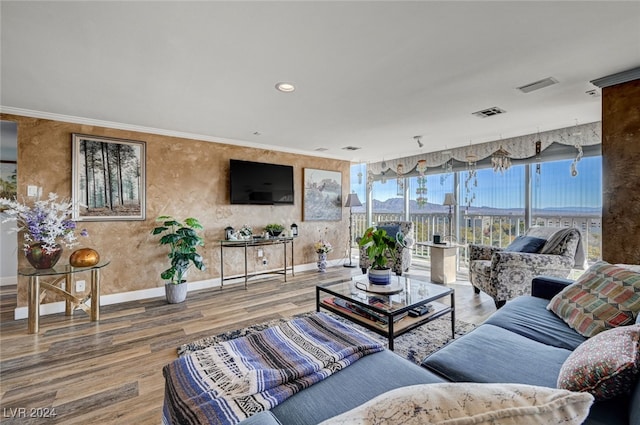 living room featuring wood-type flooring and ornamental molding