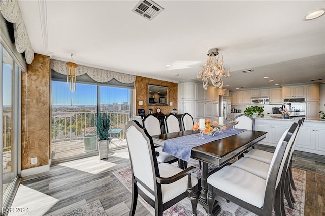 dining area featuring a notable chandelier, light wood-type flooring, and a wealth of natural light