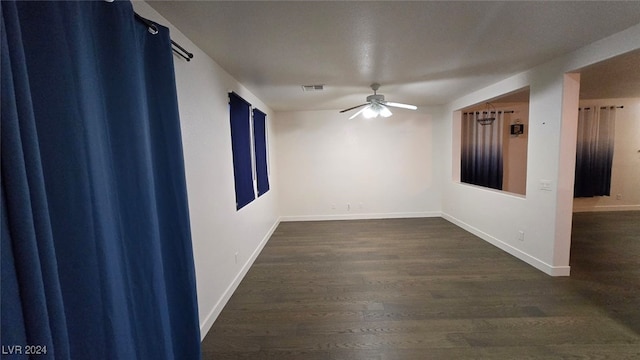 spare room featuring dark hardwood / wood-style floors and ceiling fan