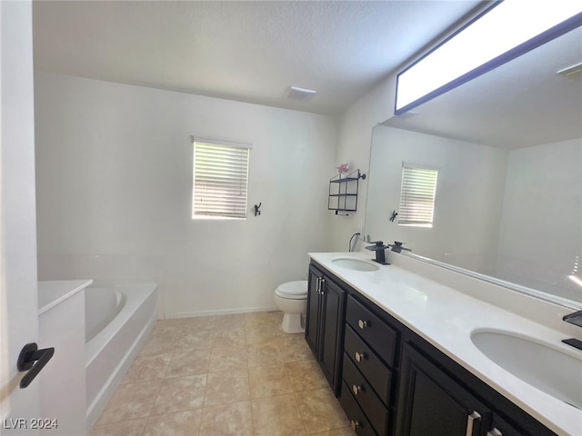 bathroom featuring a bathing tub, tile patterned flooring, vanity, and toilet