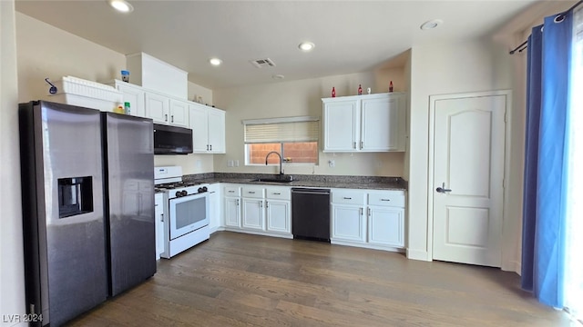 kitchen with white cabinets, sink, appliances with stainless steel finishes, and dark wood-type flooring