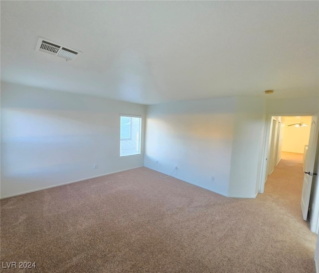 unfurnished room with light carpet