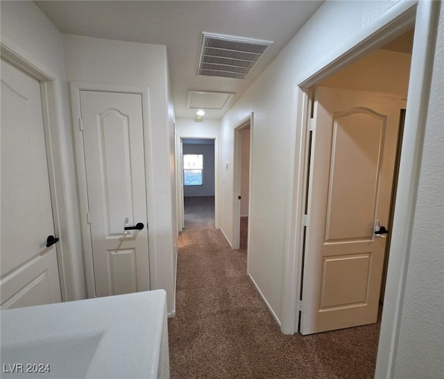 corridor with dark colored carpet