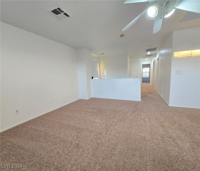 carpeted spare room with ceiling fan