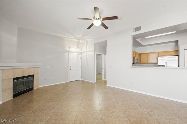 700 Carnegie St Unit 1512, Henderson, NV 89052 - unfurnished living room featuring a ceiling fan, a fireplace, baseboards, and light tile patterned floors