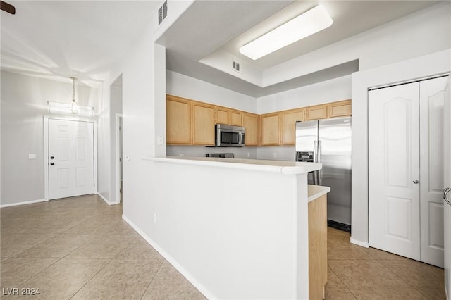 700 Carnegie St Unit 1512, Henderson, NV 89052 - kitchen with appliances with stainless steel finishes, light tile patterned floors, light countertops, light brown cabinets, and a peninsula