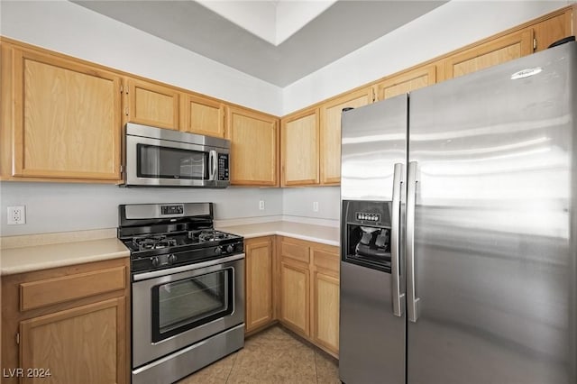 700 Carnegie St Unit 1512, Henderson, NV 89052 - kitchen featuring appliances with stainless steel finishes, light countertops, light tile patterned flooring, and light brown cabinets