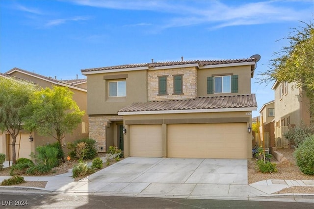 mediterranean / spanish home featuring a garage