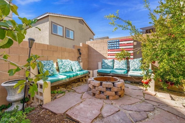 view of patio / terrace with an outdoor living space with a fire pit