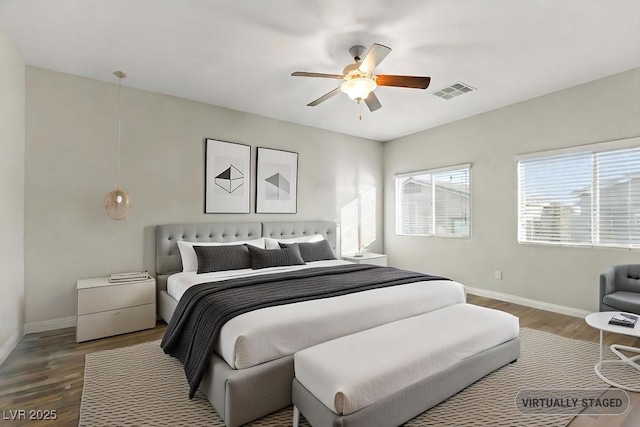 bedroom with hardwood / wood-style floors and ceiling fan