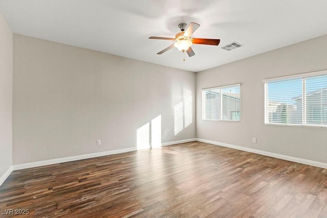 unfurnished room featuring ceiling fan and dark hardwood / wood-style flooring