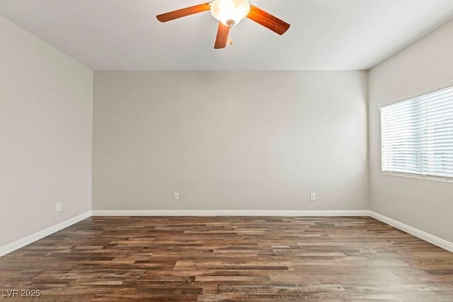 empty room with dark hardwood / wood-style flooring and ceiling fan