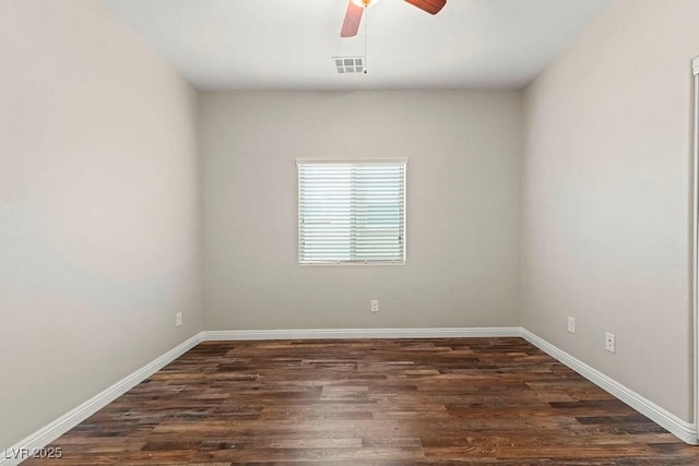 empty room with ceiling fan and dark hardwood / wood-style flooring