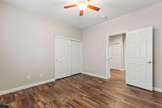 unfurnished bedroom with ceiling fan, dark hardwood / wood-style floors, and a closet