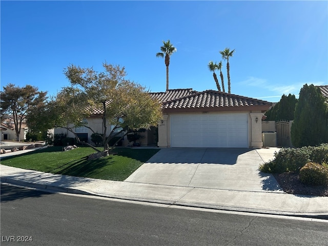 view of front facade with a garage and a front lawn