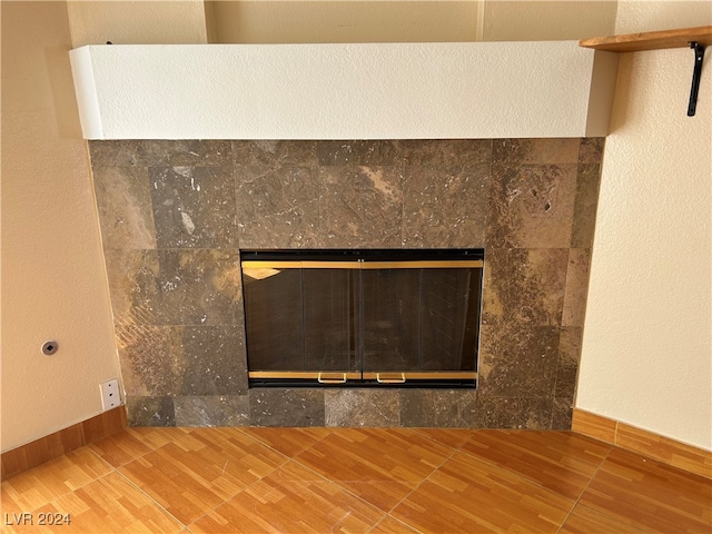 interior details with a fireplace and wood-type flooring