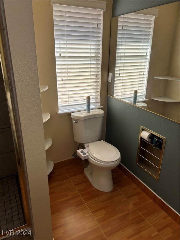 bathroom featuring hardwood / wood-style floors and toilet