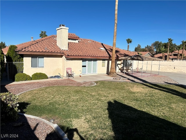 back of property featuring a pergola, a patio area, and a lawn