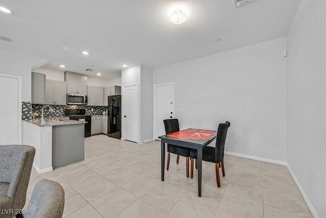 dining area with sink and light tile patterned flooring