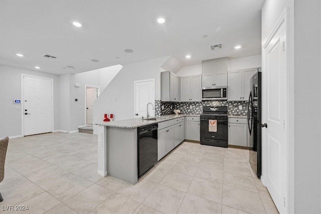 kitchen featuring backsplash, black appliances, sink, gray cabinets, and light stone counters