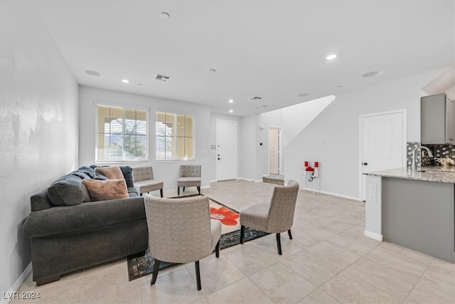 living room with sink and light tile patterned floors