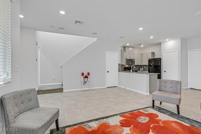 living room featuring light tile patterned floors and sink