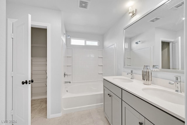 bathroom with tile patterned floors, vanity, and shower / tub combination