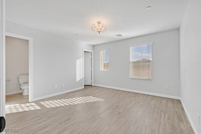 unfurnished room with light hardwood / wood-style floors