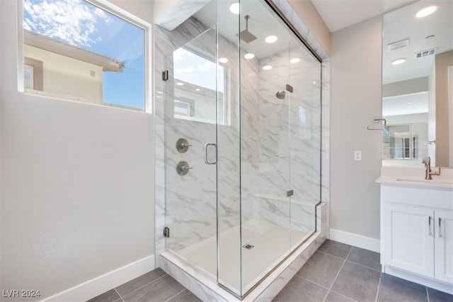 bathroom with tile patterned floors, vanity, and a shower with shower door