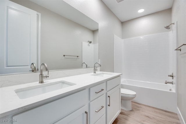 full bathroom featuring vanity, hardwood / wood-style floors,  shower combination, and toilet