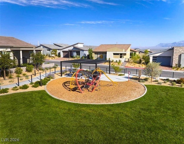 view of jungle gym featuring a mountain view and a yard