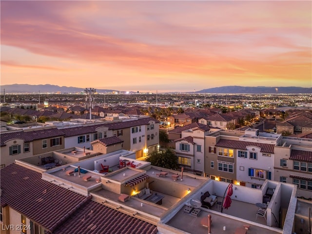 aerial view at dusk featuring a mountain view