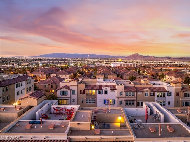 aerial view at dusk featuring a mountain view