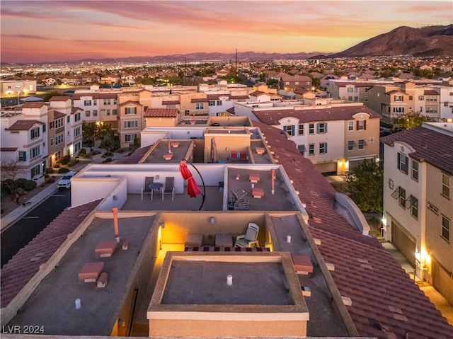 aerial view at dusk featuring a mountain view