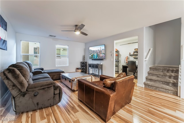 living room featuring ceiling fan and light wood-type flooring