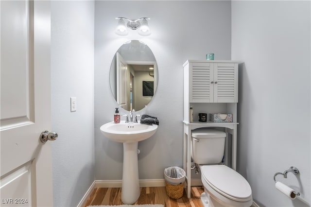 bathroom featuring hardwood / wood-style floors and toilet