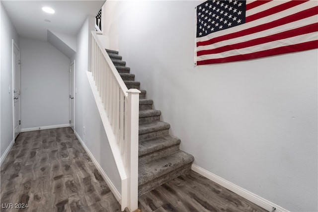 stairs featuring wood-type flooring