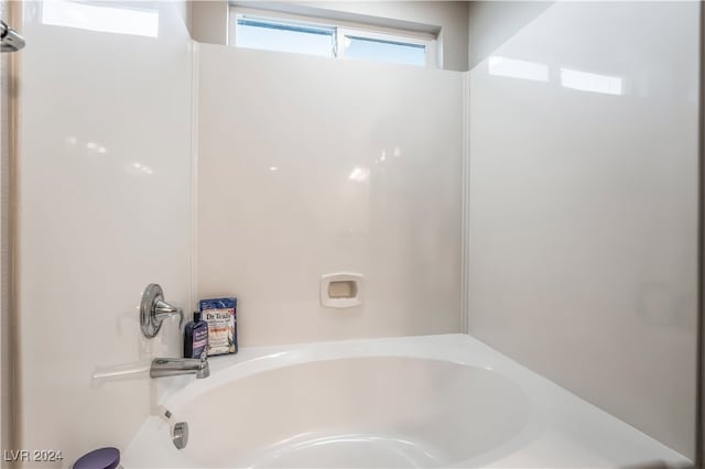 bathroom with a tub to relax in