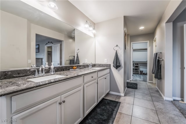 bathroom with tile patterned flooring and vanity