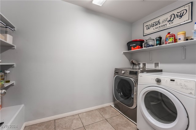 washroom with separate washer and dryer and light tile patterned flooring