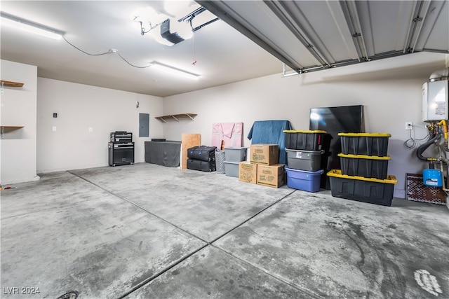 garage featuring electric panel, water heater, and a garage door opener