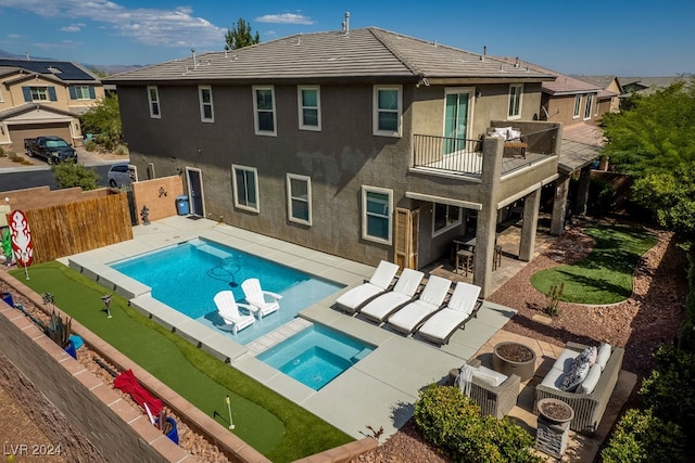 view of swimming pool with an in ground hot tub and a patio