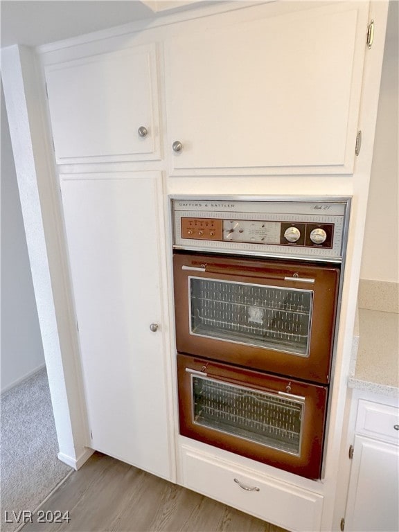 room details with hardwood / wood-style floors and oven