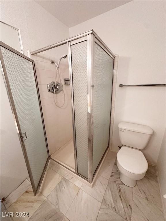 bathroom with toilet and walk in shower