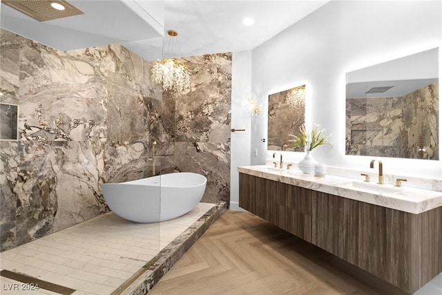 bathroom with parquet flooring, tile walls, vanity, and a bathing tub