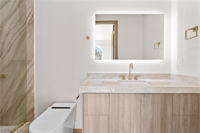 bathroom with toilet and vanity