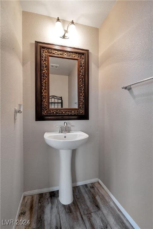 bathroom with wood-type flooring